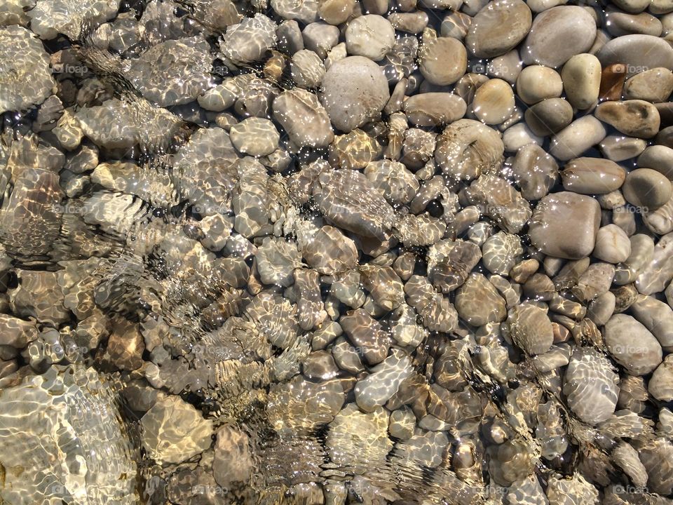 Rocks and sunny water ripples