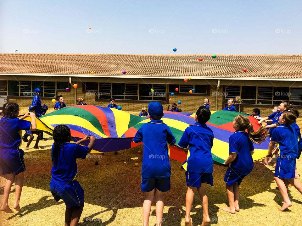 Memories of summer. What fun to play with balls on a parachute 