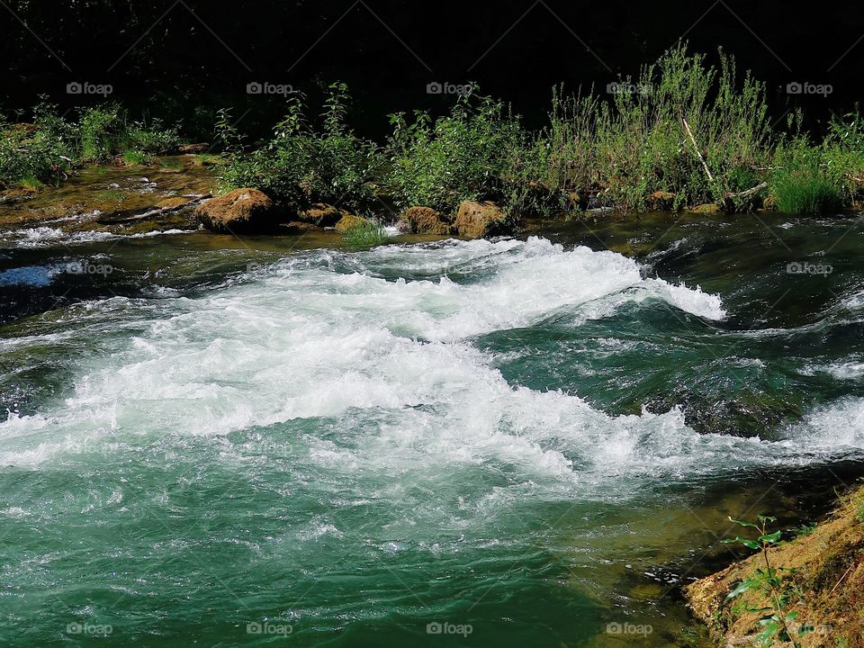 The fresh waters of the McKenzie River on a hot summer day in the Willamette National Forest in Western Oregon. 