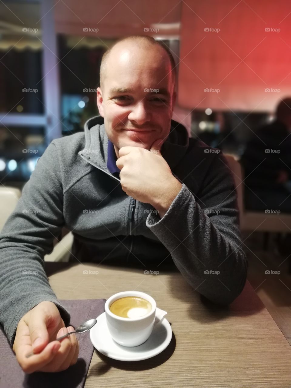 Man drinking coffee at a café, date night