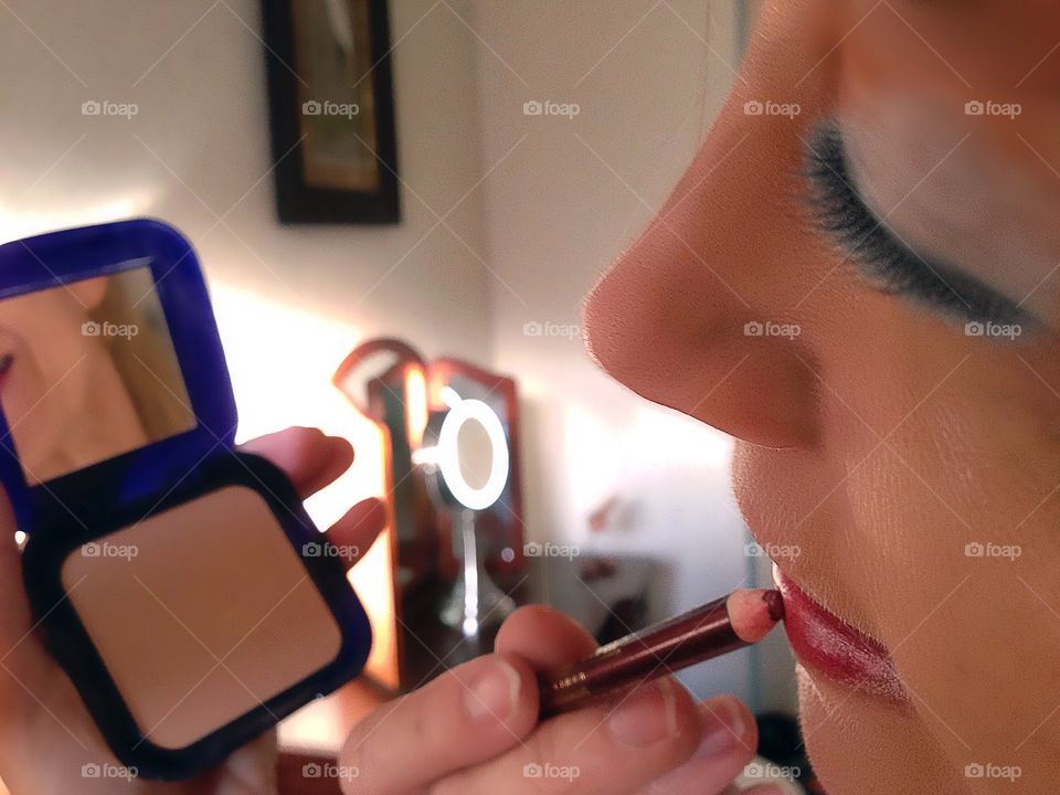Woman applying cosmetics.