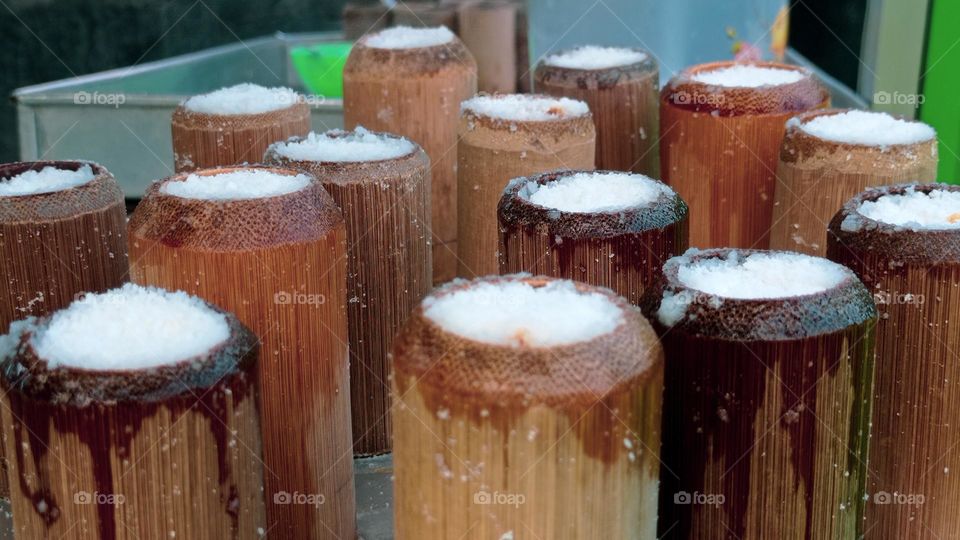 Portrait of Putu Cake, a typical Indonesian street food that is processed by inserting it into pieces of bamboo and steaming it in a pan on the stove. Healthy Food For Vegan.