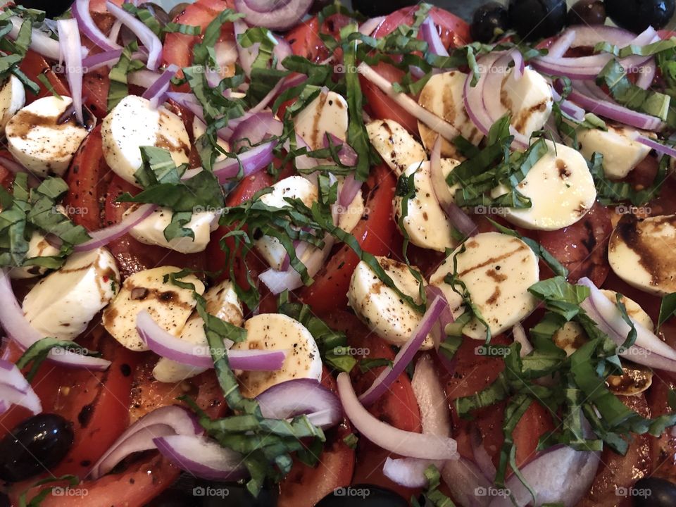 Close up of a healthy caprese salad with balsamic vinegar