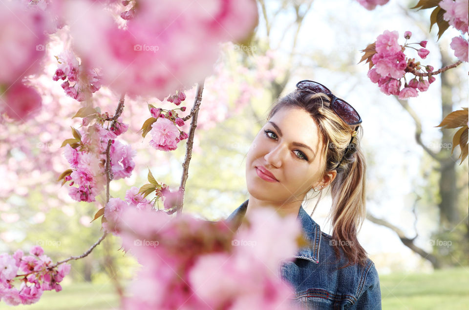 Portrait of a pretty woman near flower tree
