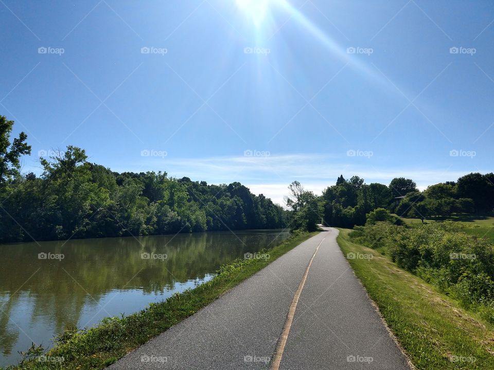 long bicycle path next to a calm river