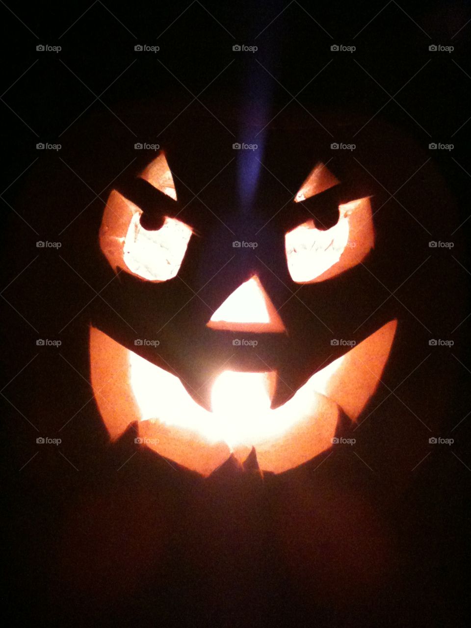 Smiley Halloween pumpkin lit with tea lights 

