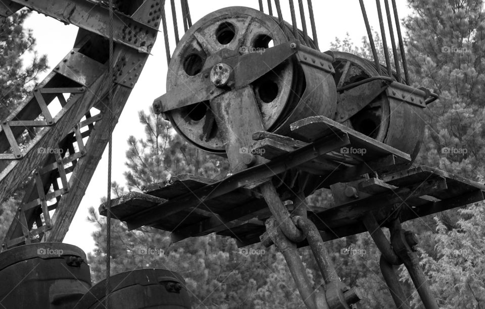 Giant iron pullies for a crane attached to an old dredging machine. 