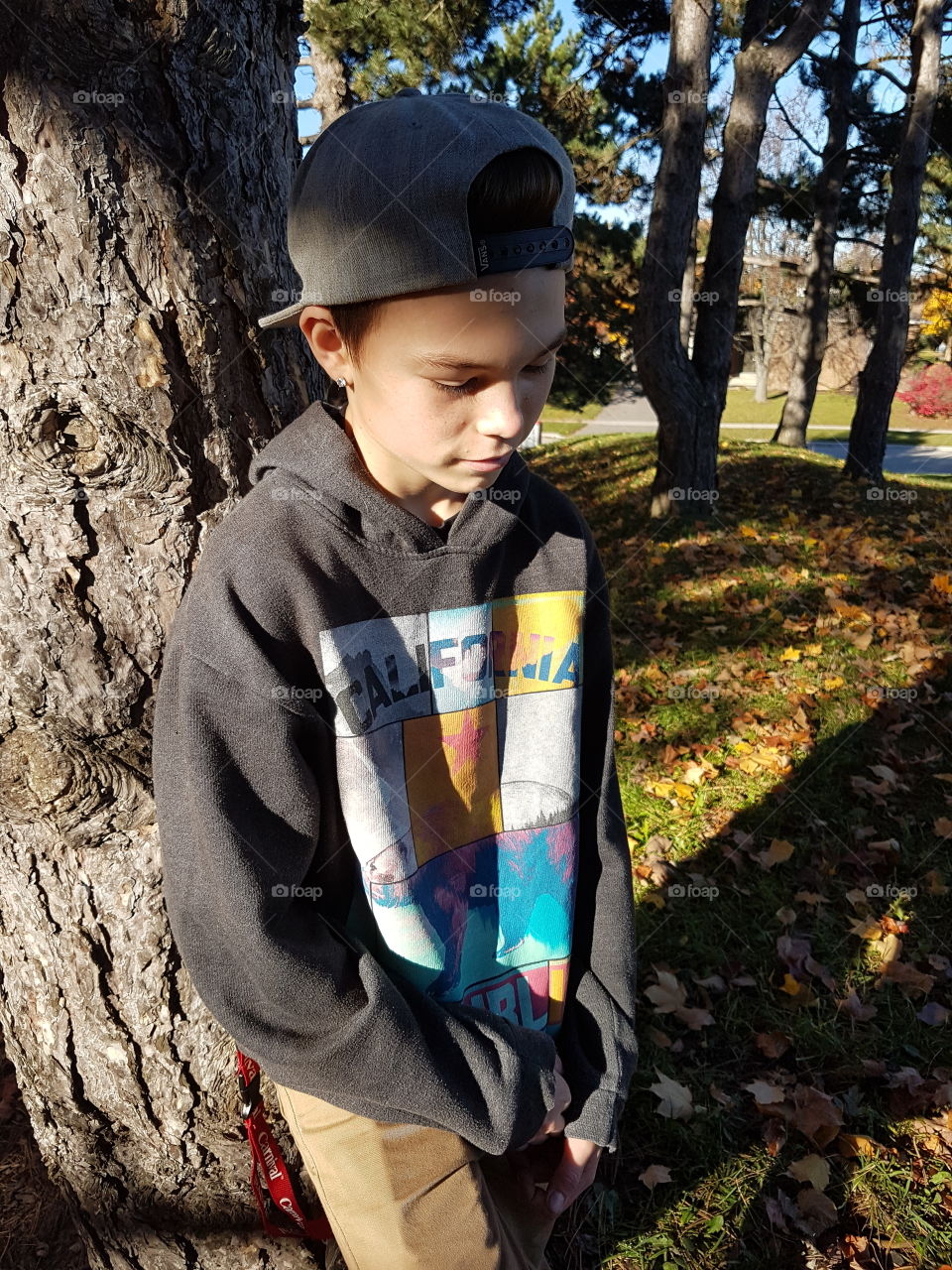 teen boy against tree