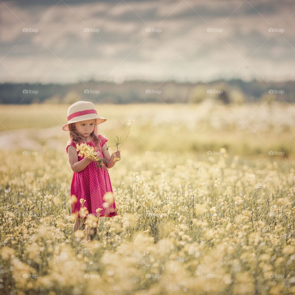 Little girl in blossom meadow