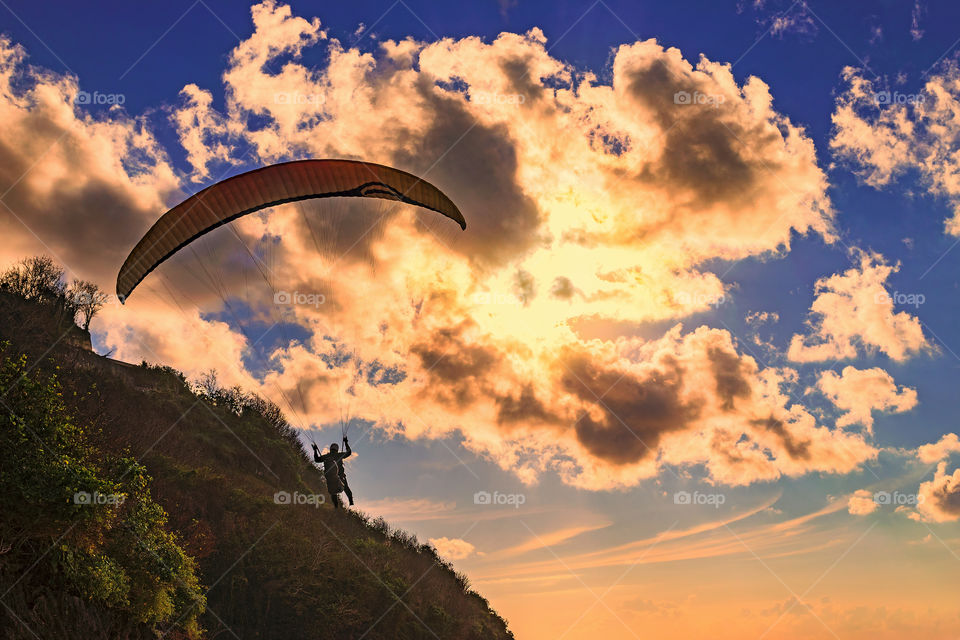 Paraglider hovering over the beach