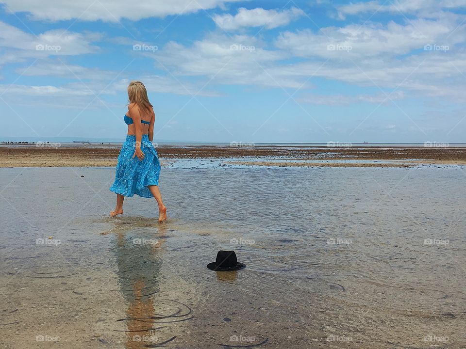 Rear view of woman walking on the beach