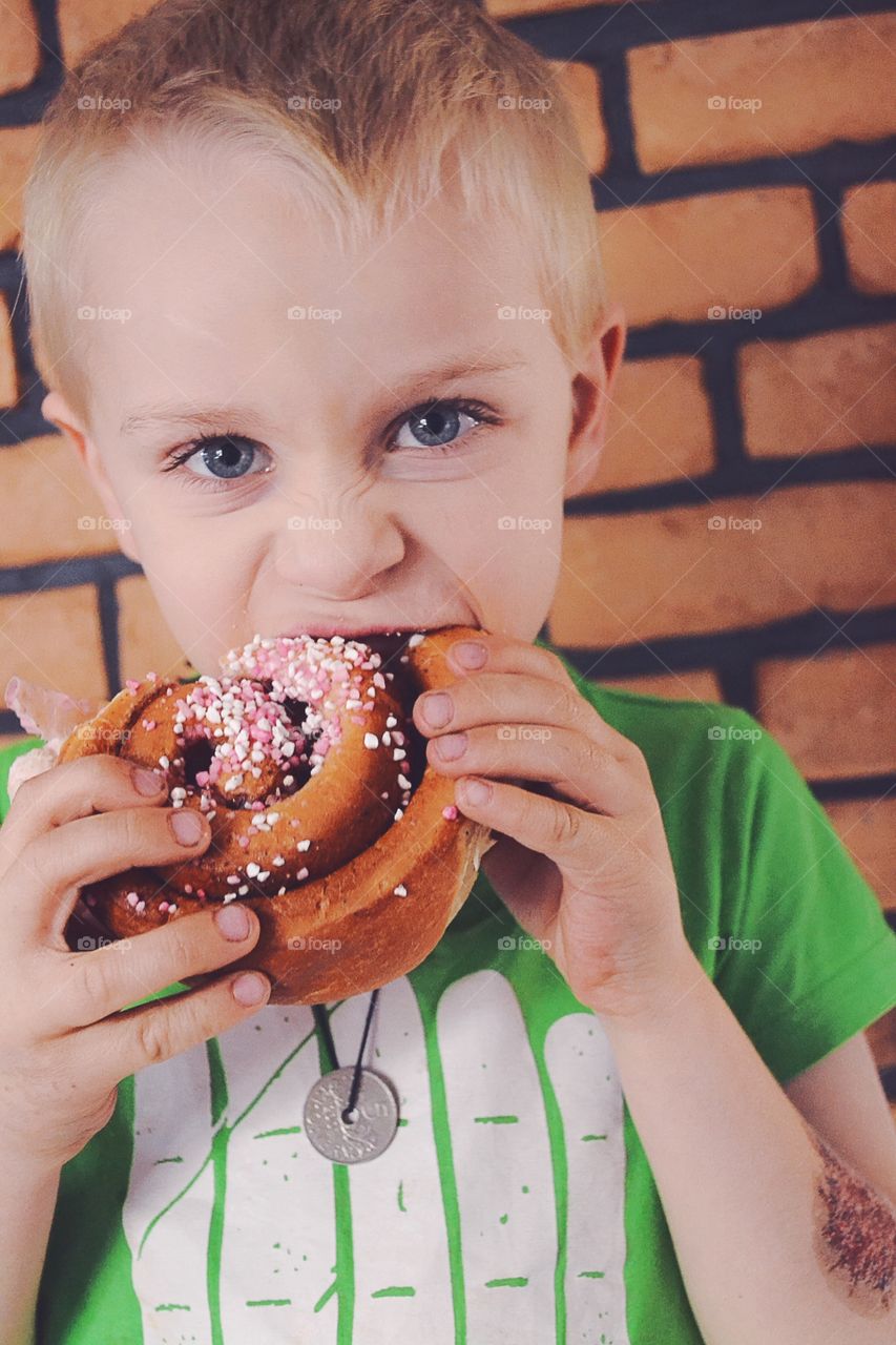 Boy with a big cinnamon bun