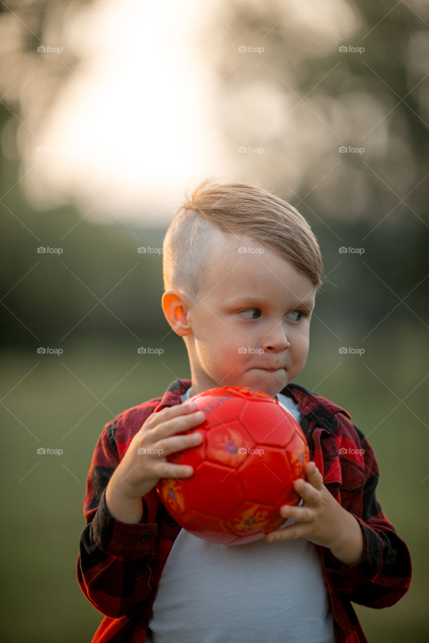 Little boy playing in soccer in a park 