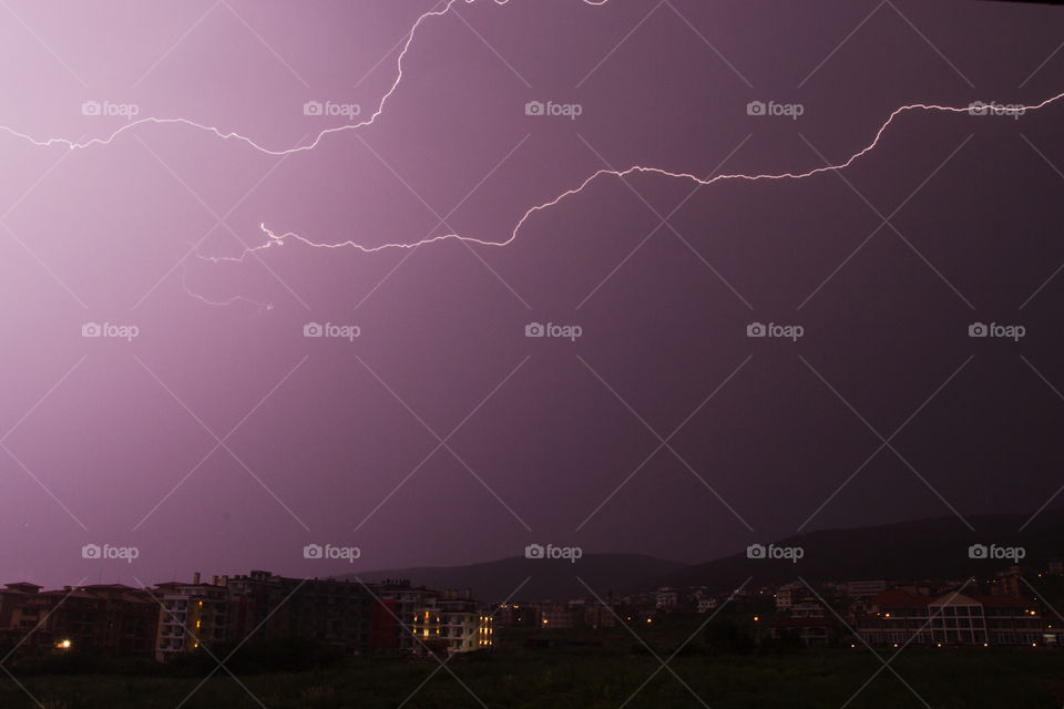 Scenic view of thunderstorm in city