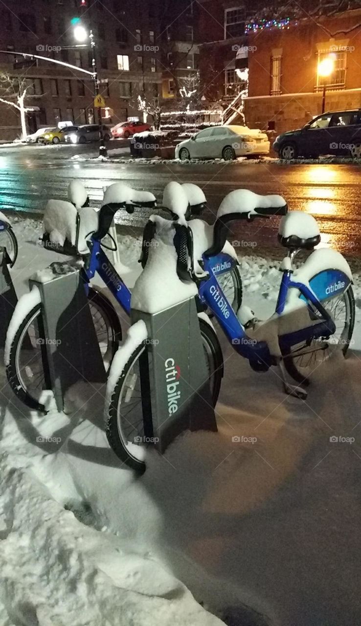Bikes Under Snow Nighttime NYC