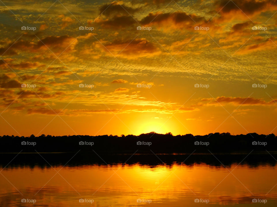 Idyllic view of lake against dramatic sky