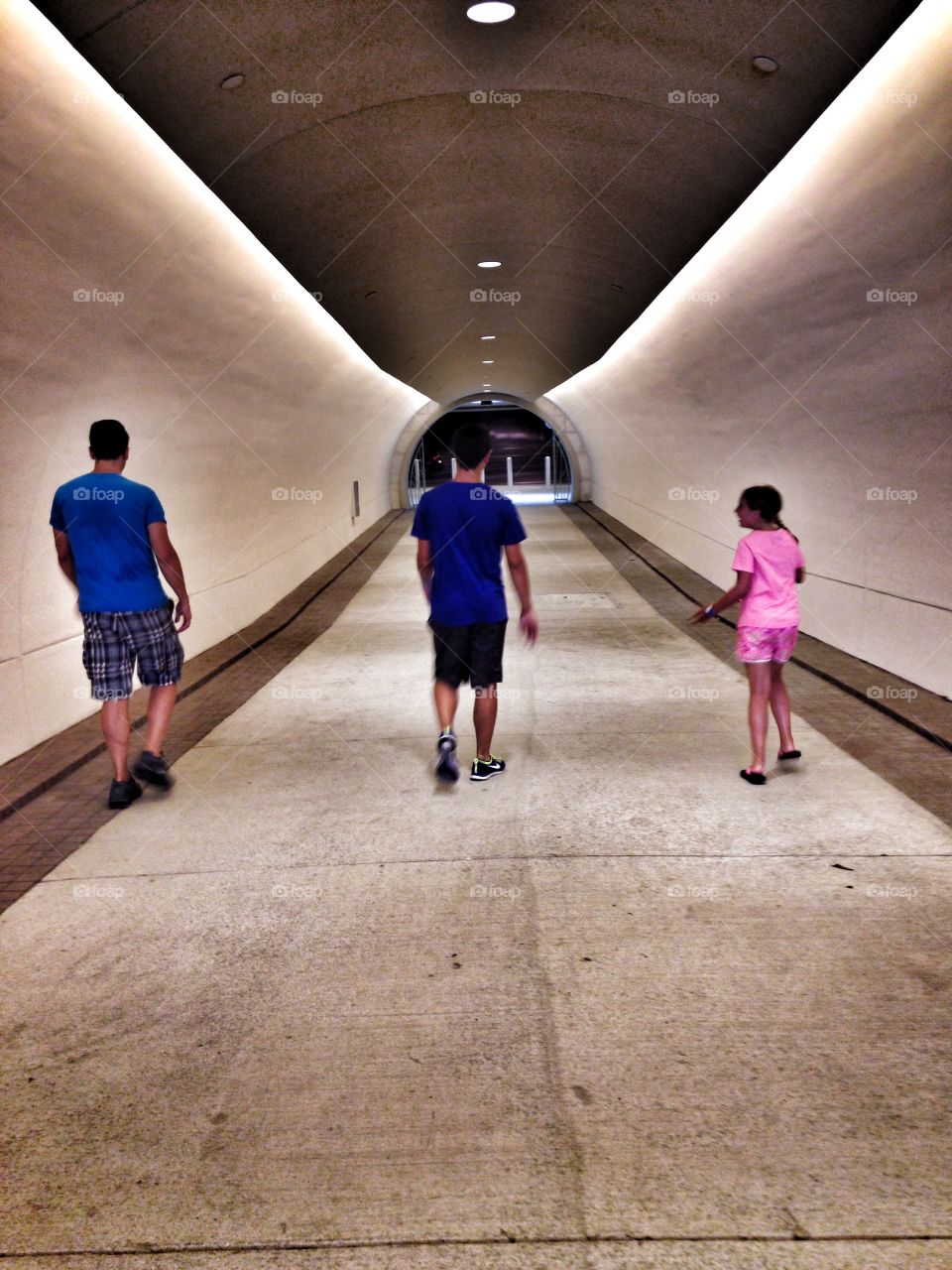 Safe passage. Family walking in a tunnel under a
Road