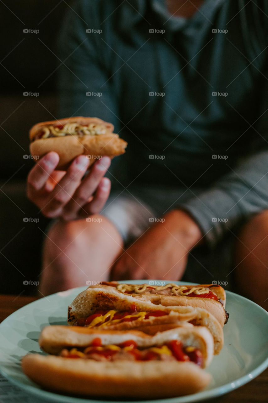 Man eating hot dogs