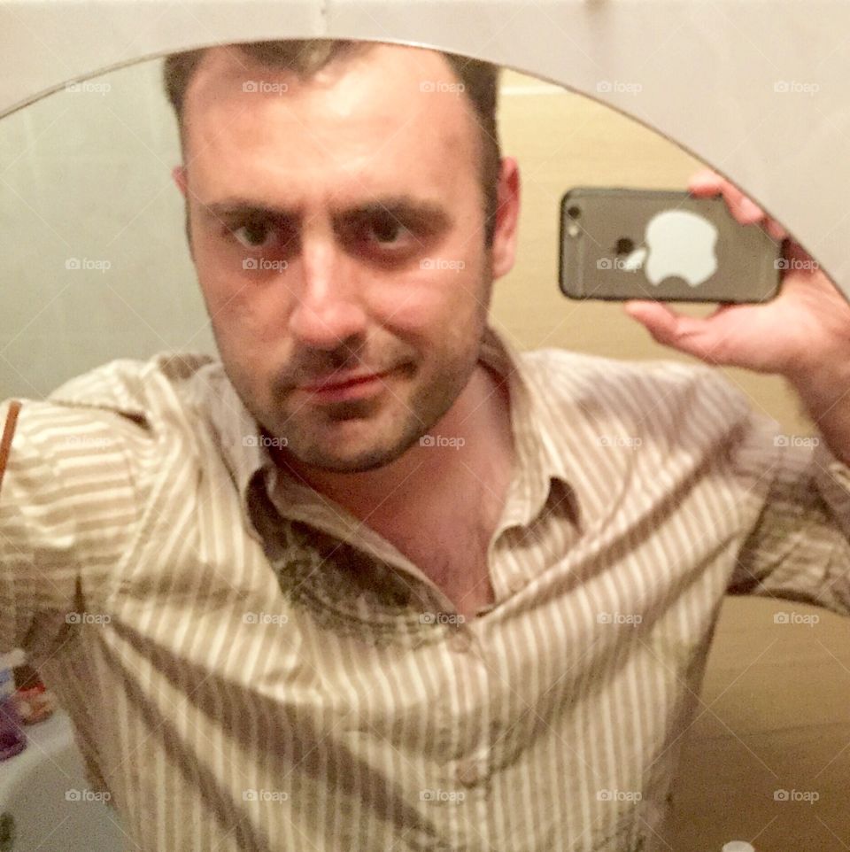 Man taking selfie in mirror reflection