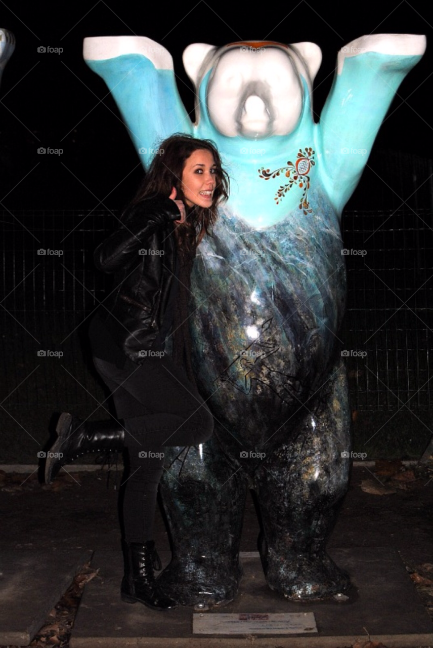 Girl hugging a bear in Paris. Girl smiling and hugging a buddy bear in Paris