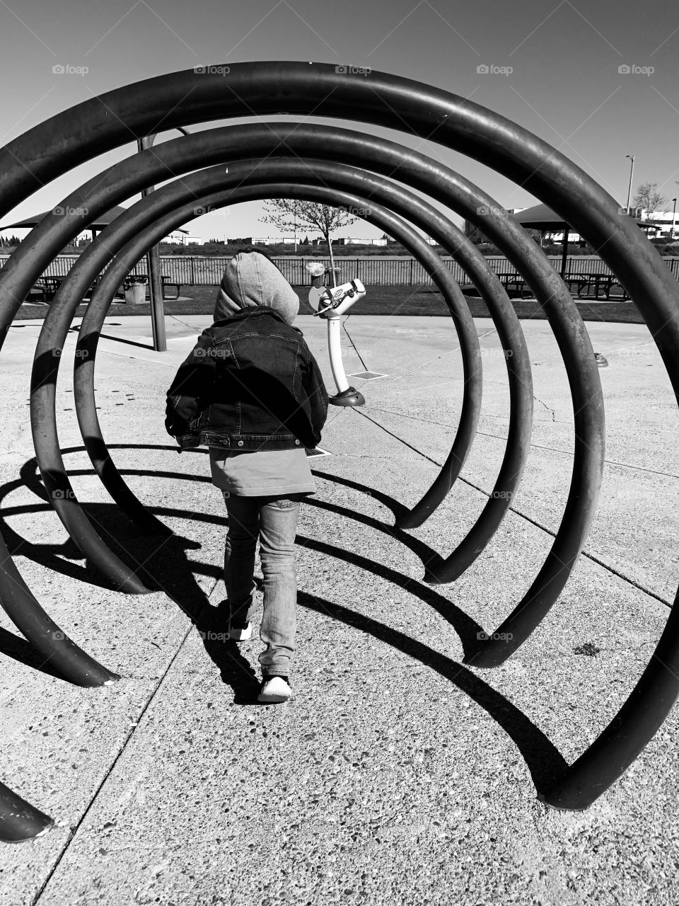 Black and white Abstract image of a child playing outdoors at the park - park sculpture 