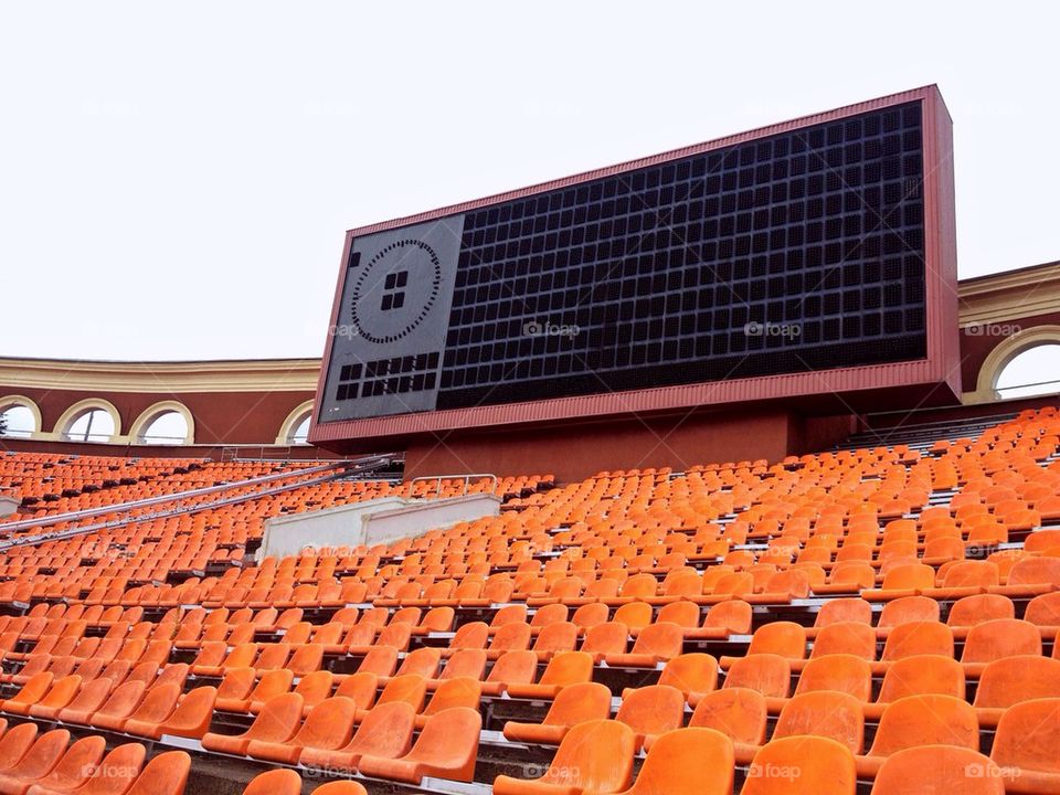 Score board and rows of seats at old football stadium