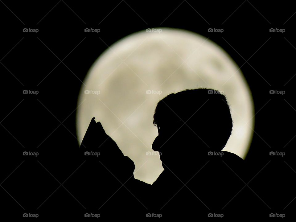 My brother with the moon behind him