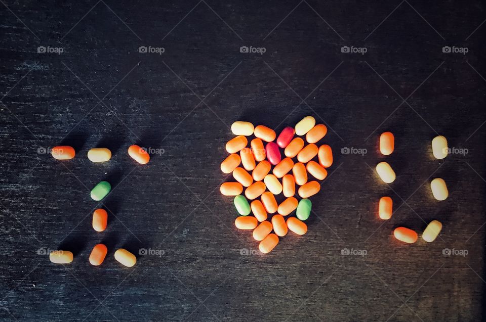 I love you written with hard pieces of candy on a black background. Valentine’s Day 