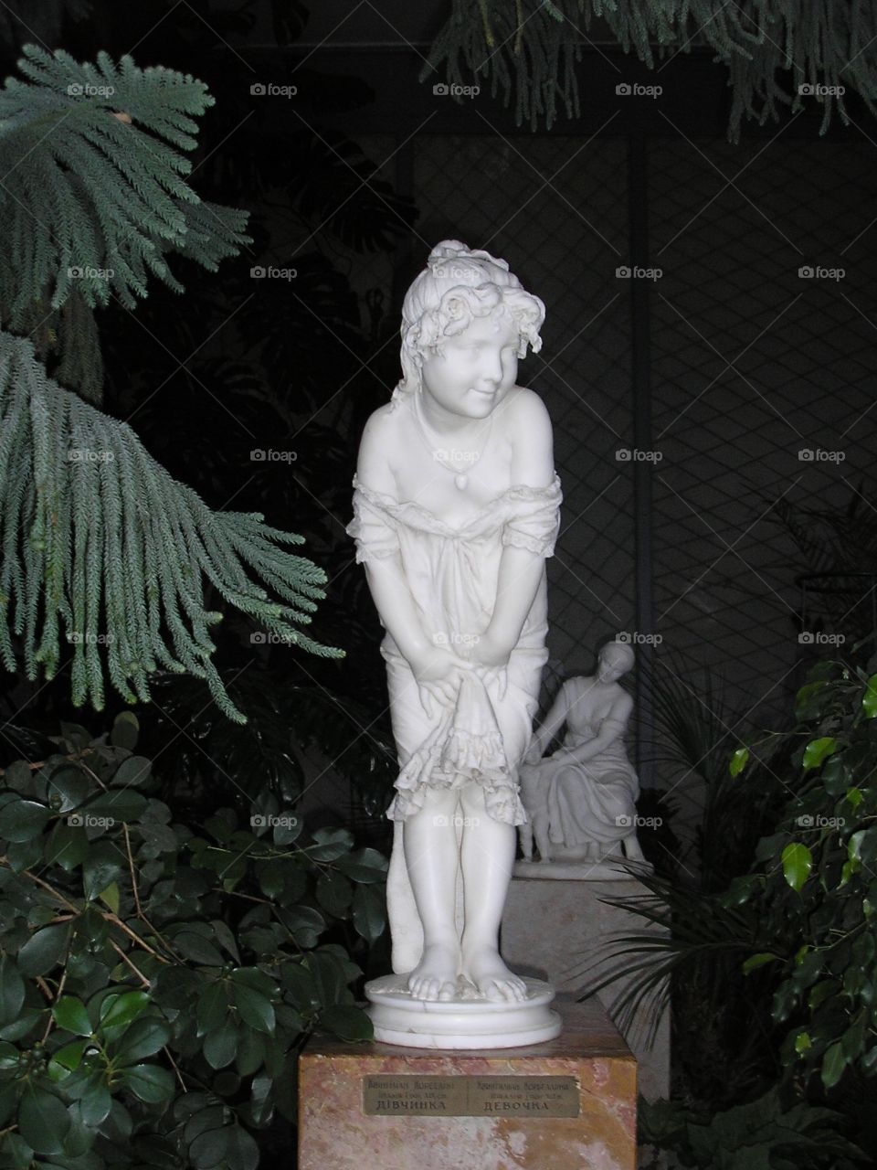 A statue of a little girl smiling in the Summer Garden of Vorontsov Castle