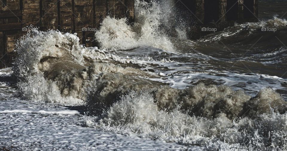 The rough and choppy English Channel pounding the beach near Rye, Kent