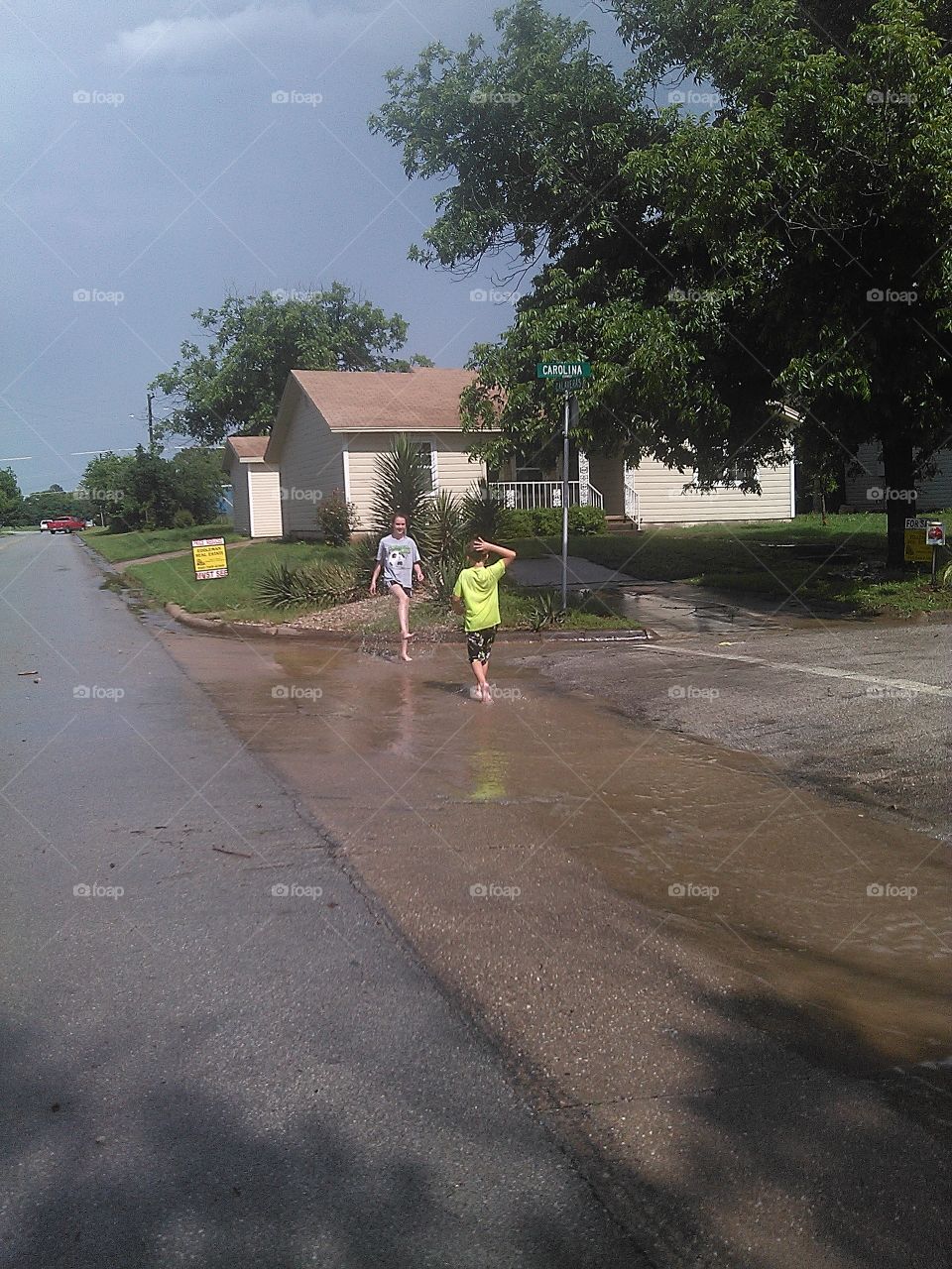 playing in the rain. i used to do this when i was a kid