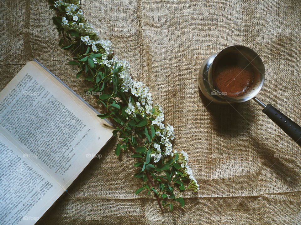 Coffee, flowers and a favorite book