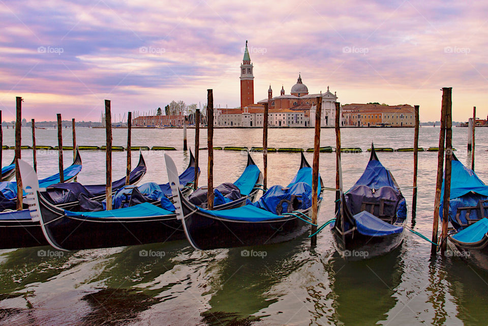 Sunrise in Venice. View from St Marc's square over the lagoon with gondolas. 