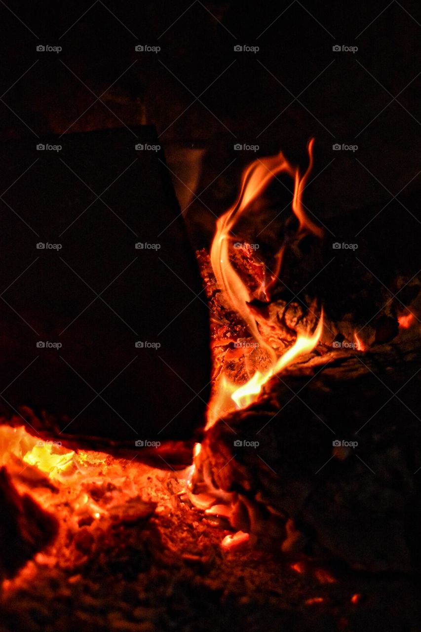 Fire consuming wood in a fireplace 