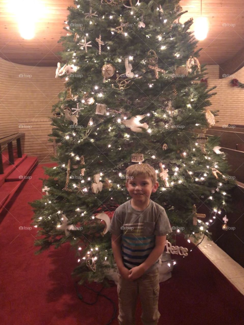 My nephew in front of the tree at church 