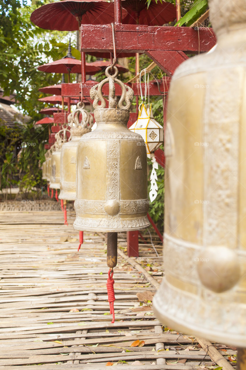 Row of golden bells outside a temple