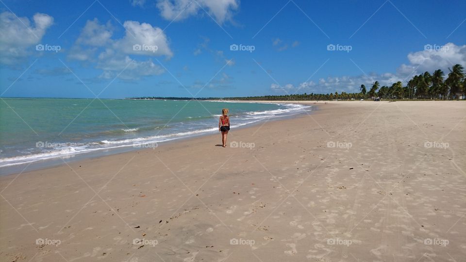 Woman walking in the beach. Porto de Gallinas. Brazil 
