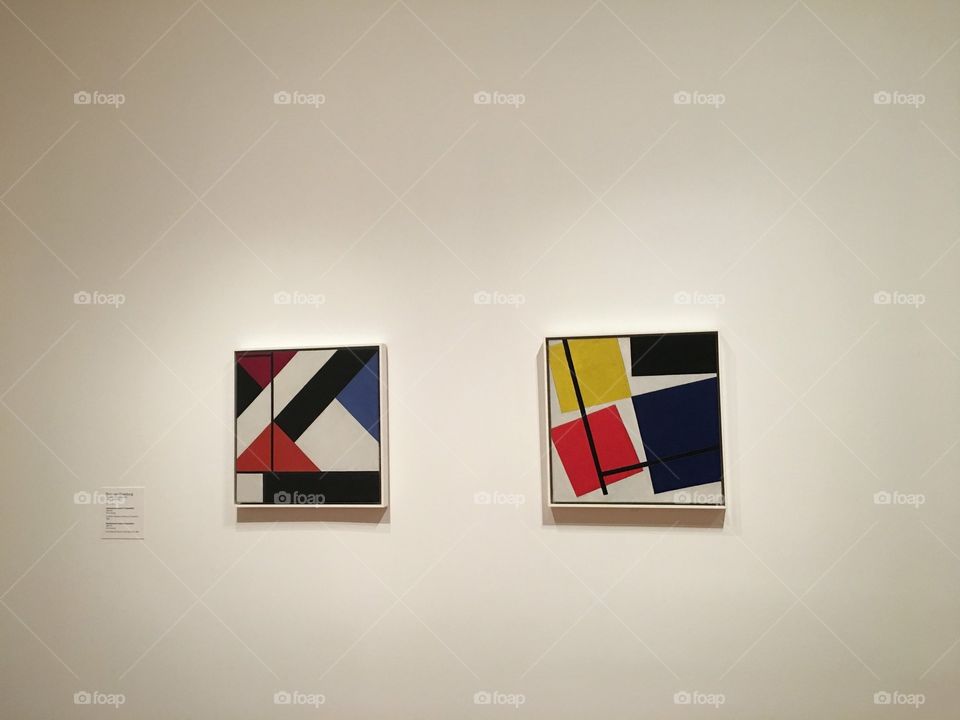 2 geometric pieces of artwork on the wall at the MOMA.