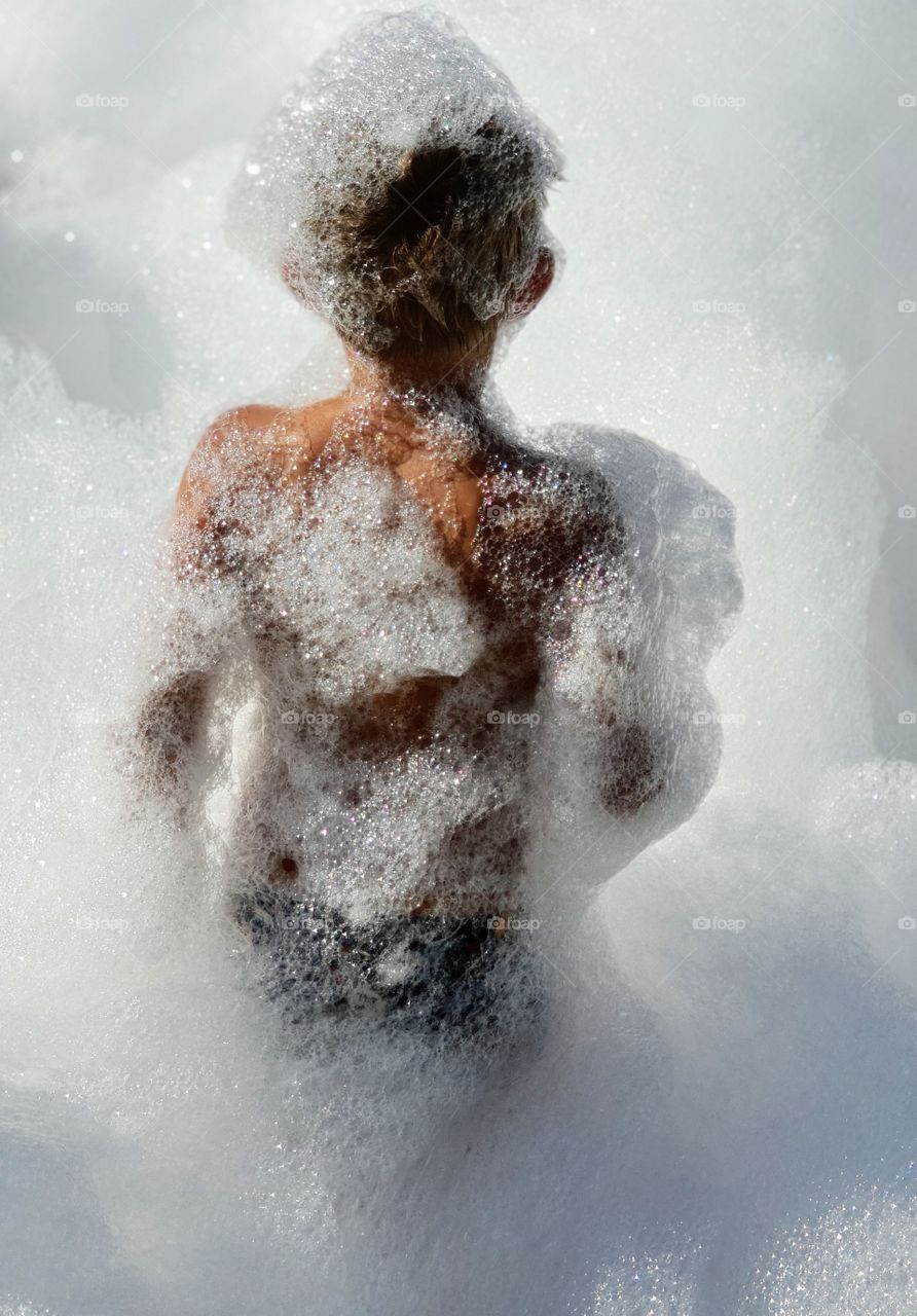 boy from behind covered in foam