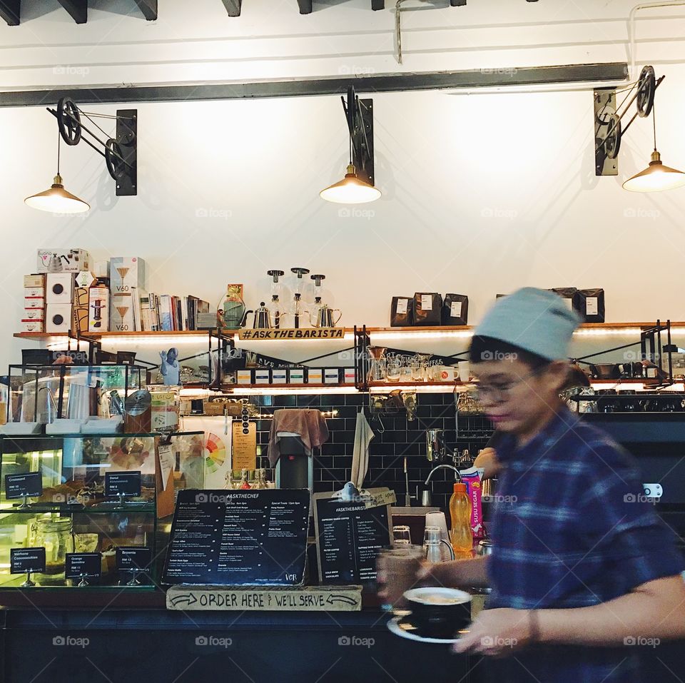 A cafe scene with a server carrying drinks.