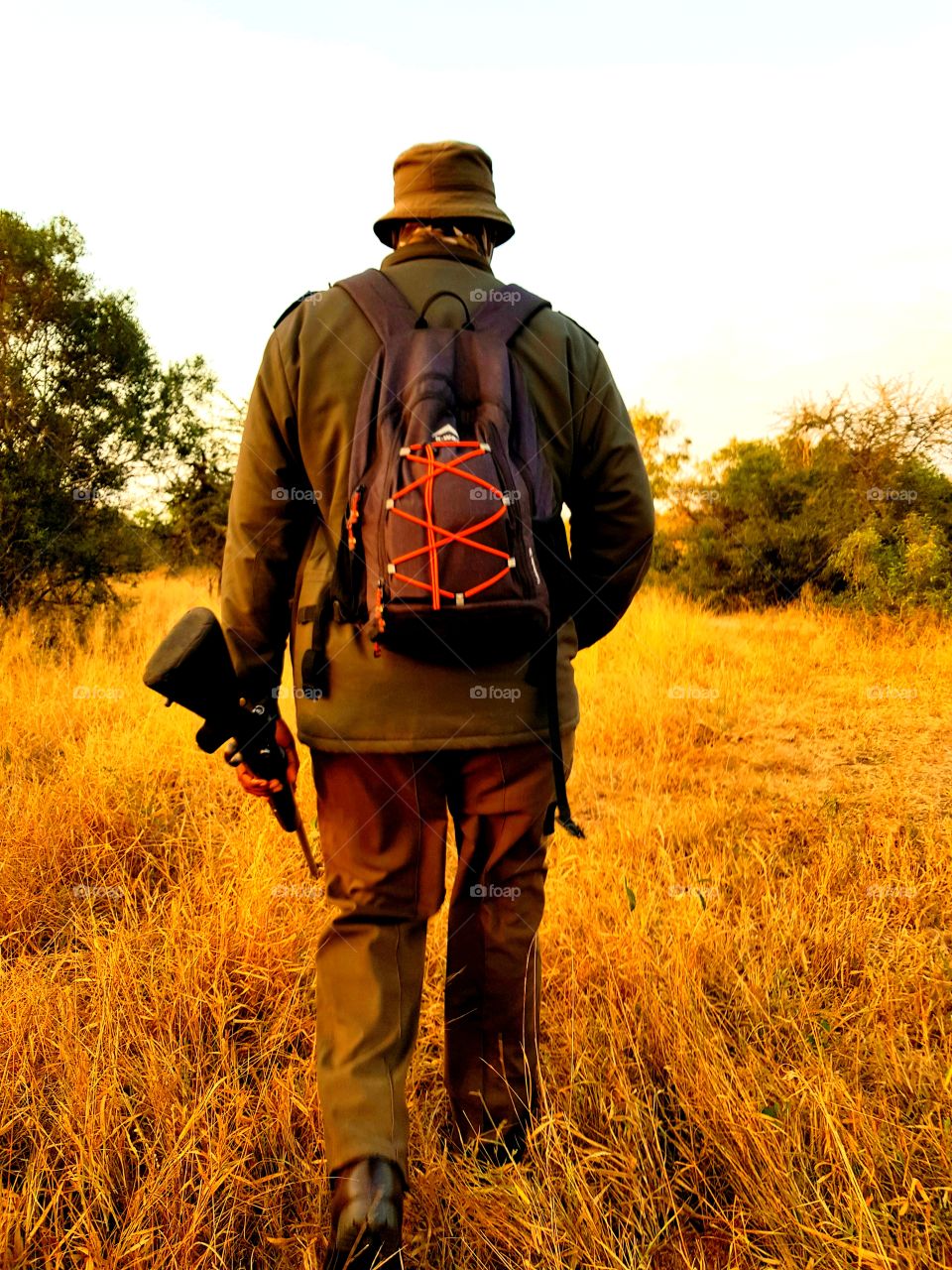 An armed security guard walked in the front to protect and lead tourists during a sunrise walk in Kruger National Park, South Africa.