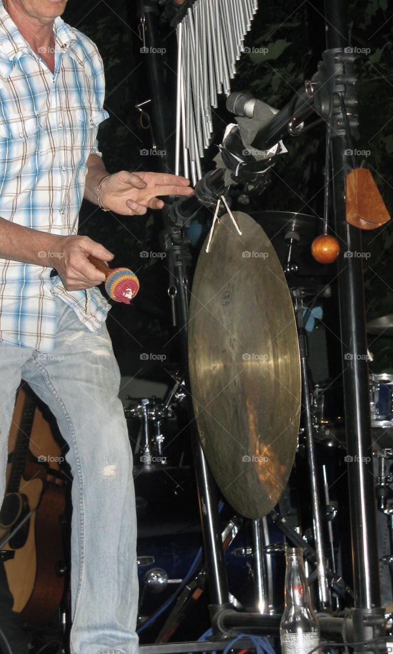 A man playing cymbal & chimes