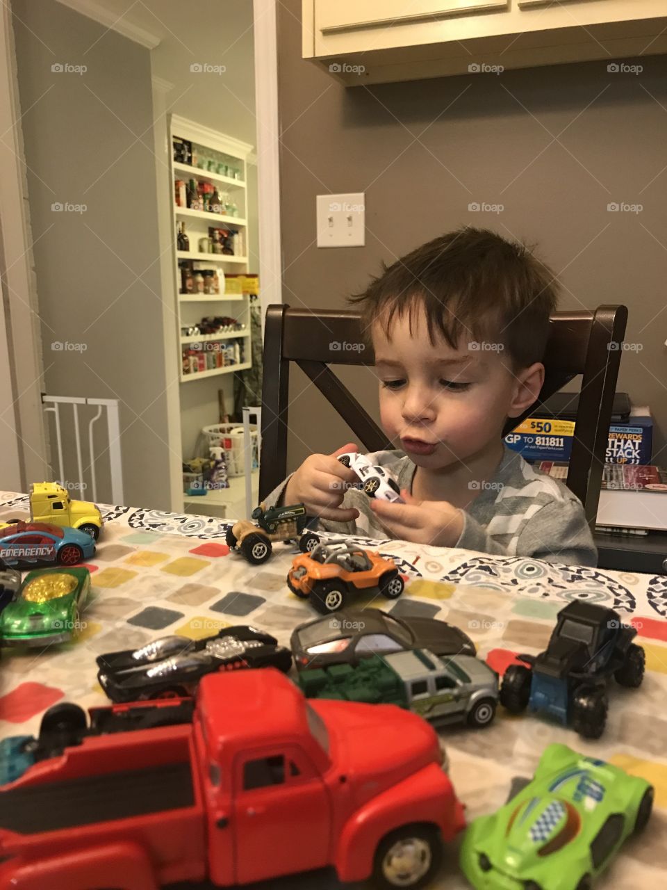 Boy and his matchbox cars 