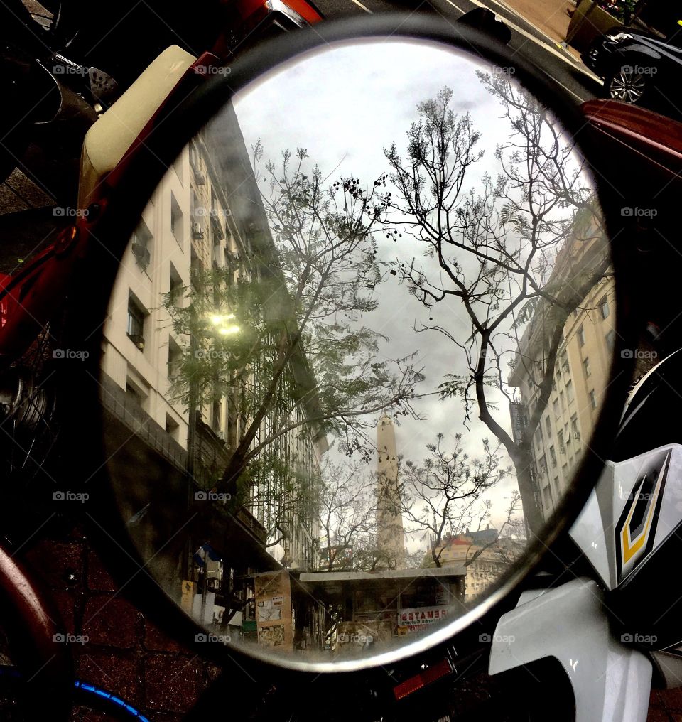 Reflection of the obelisk in a motorcycle rear view