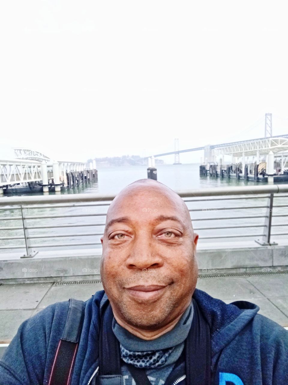 selfie pic, on the boardwalk, Pier one in San Francisco with the Bay bridge in the background