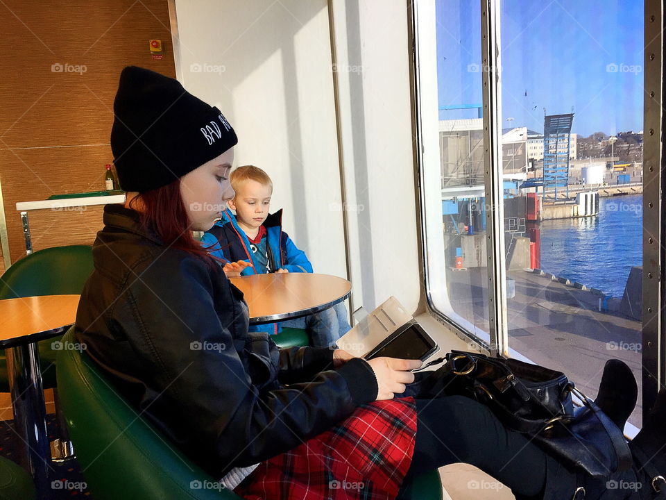 A boy and a girl traveling, girl using her phone