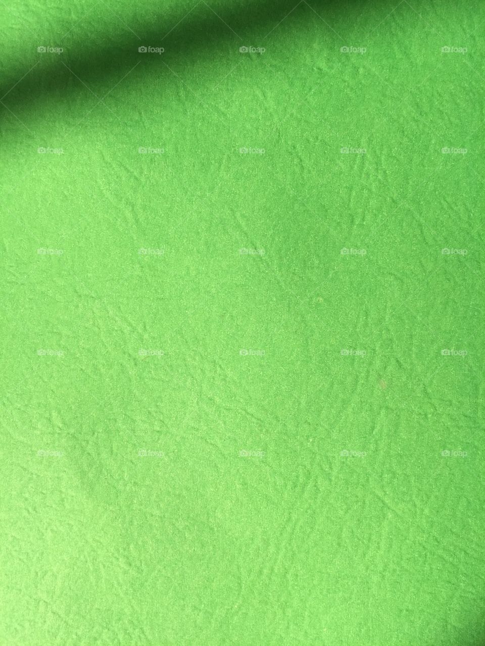 Bright vivid green textured paper 