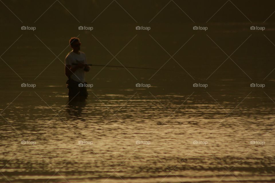 Fisherman At Dusk