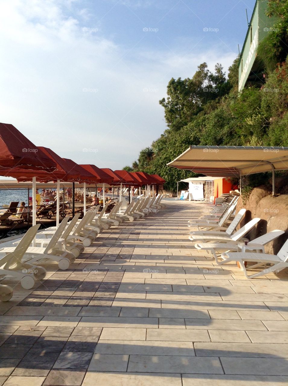 Sunbeds with parasols on a sea coast 