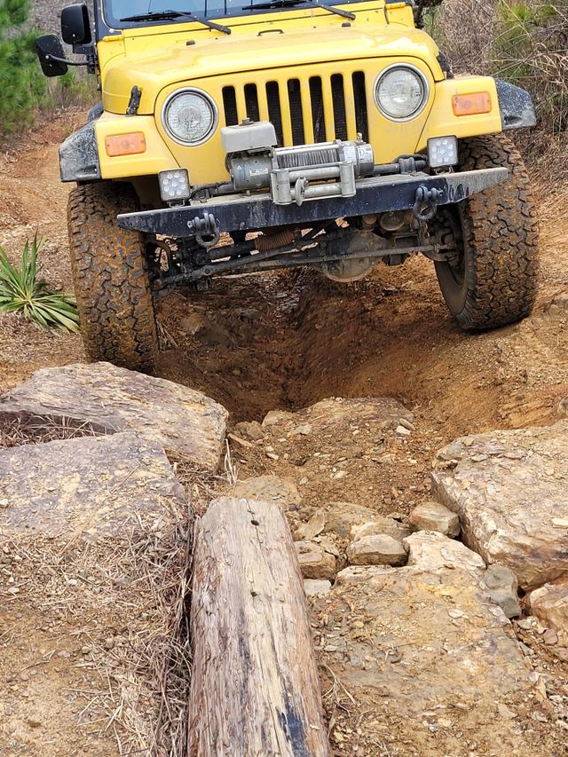 Jeep driving over rocks